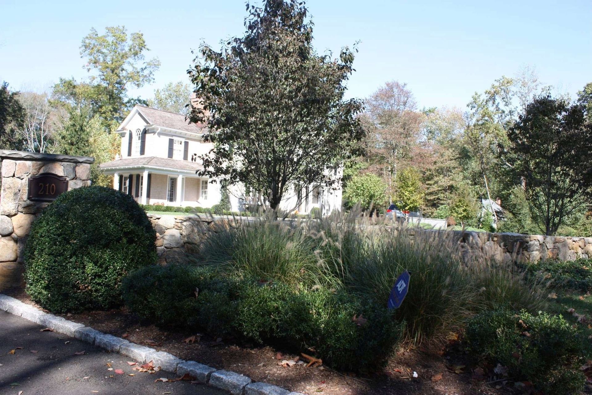 A large house is surrounded by trees and bushes