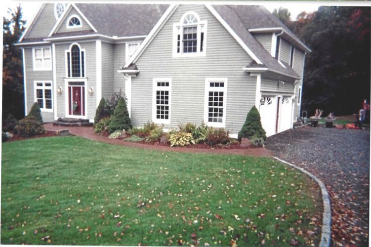 A large house with a lush green lawn in front of it