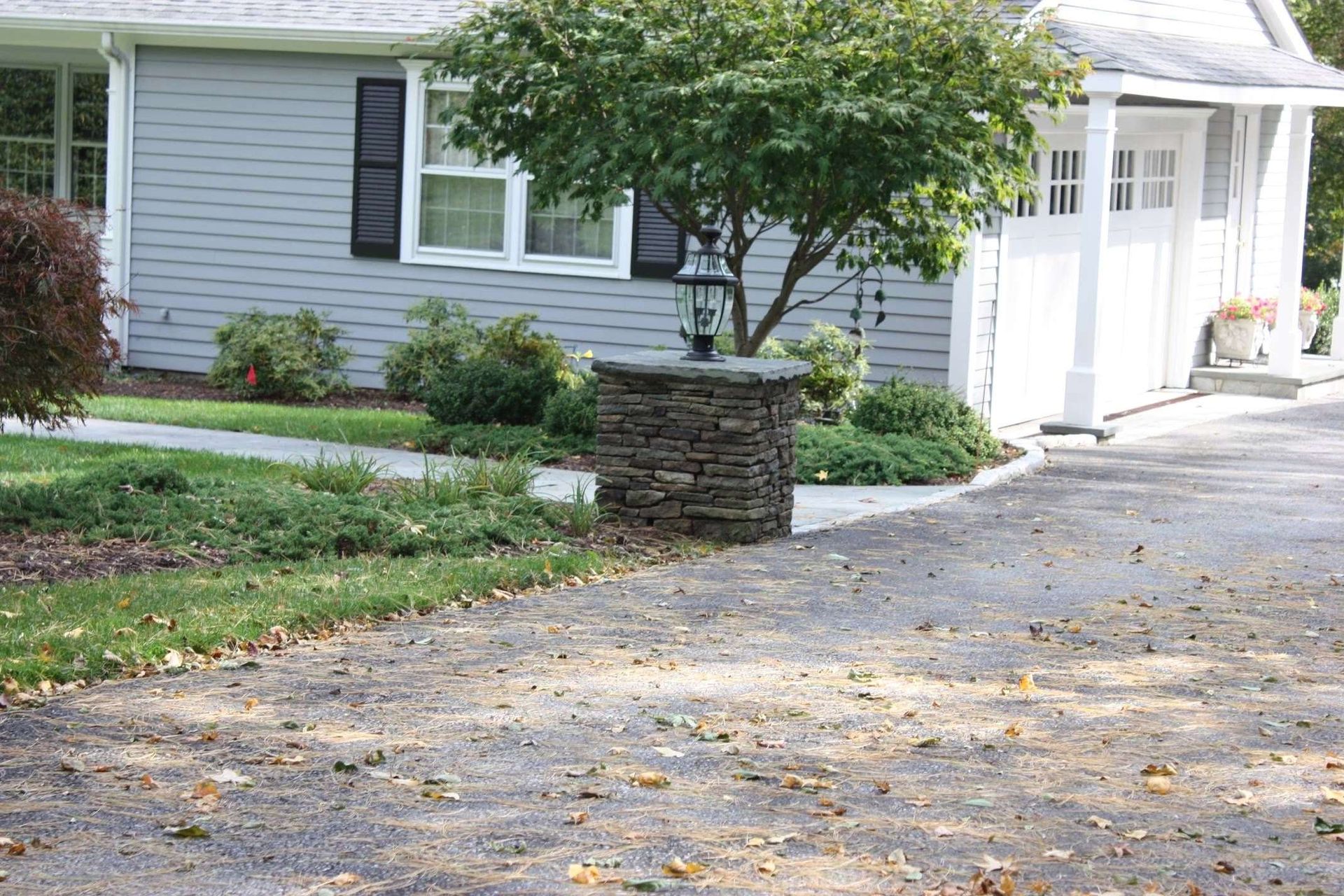 A house with a stone pillar in front of it