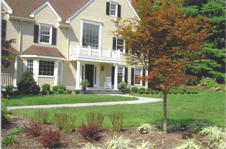A large house with a lush green lawn in front of it