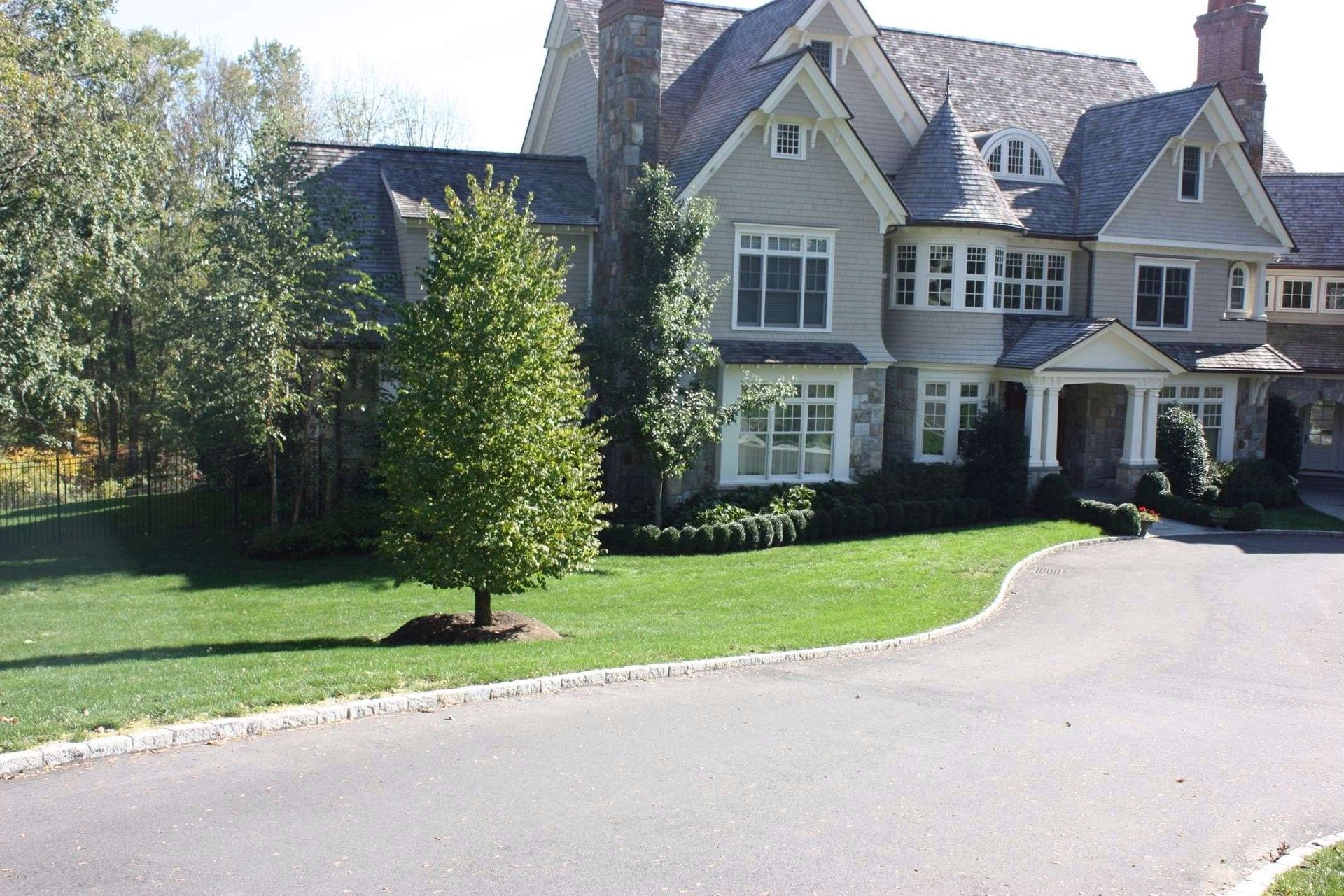 A large house with a driveway leading to it