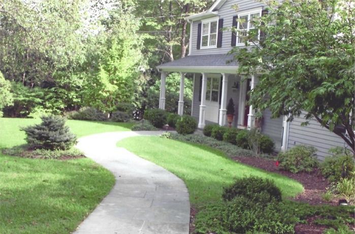 A house with a porch and a walkway leading to it