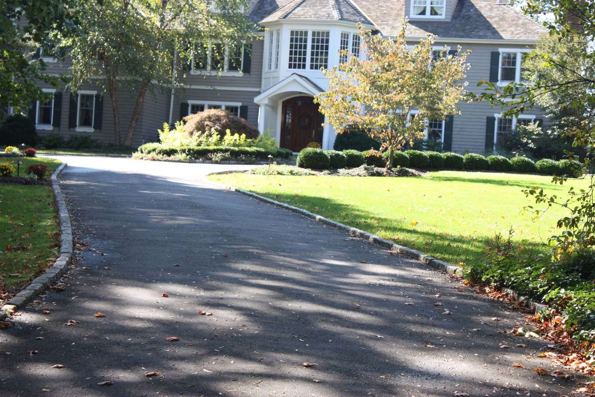 A large house with a driveway leading to it