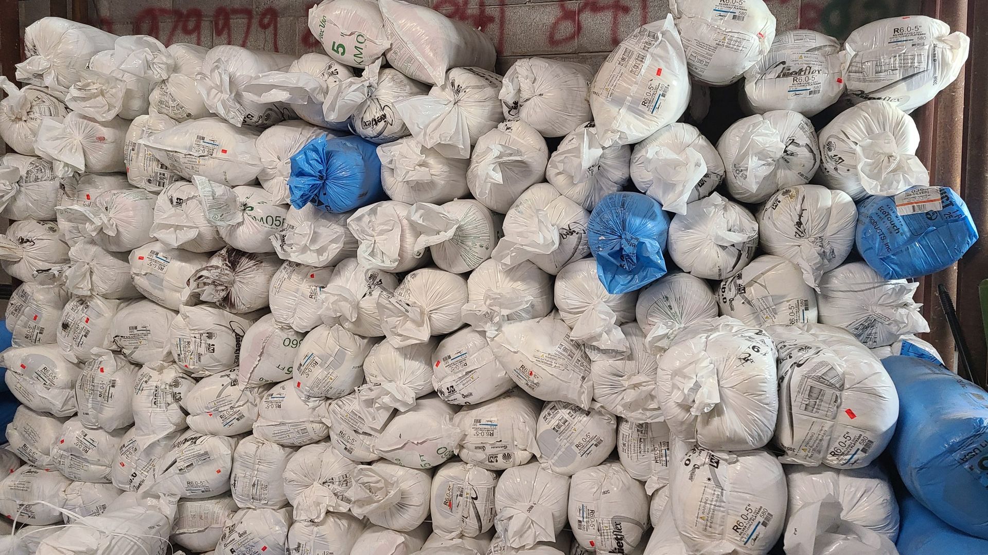 A pile of bags stacked on top of each other.