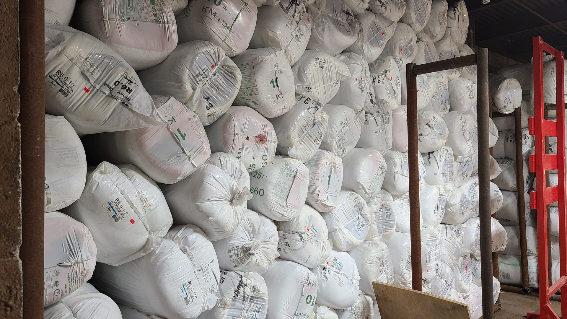 A warehouse filled with lots of white bags stacked on top of each other.