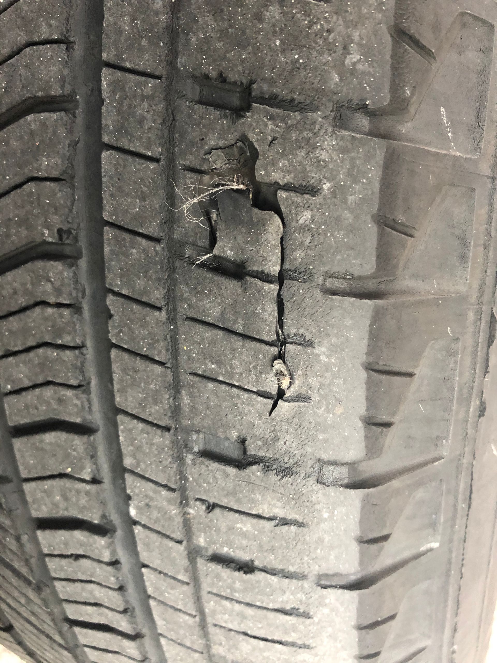 A close up of a tire with a hole in it