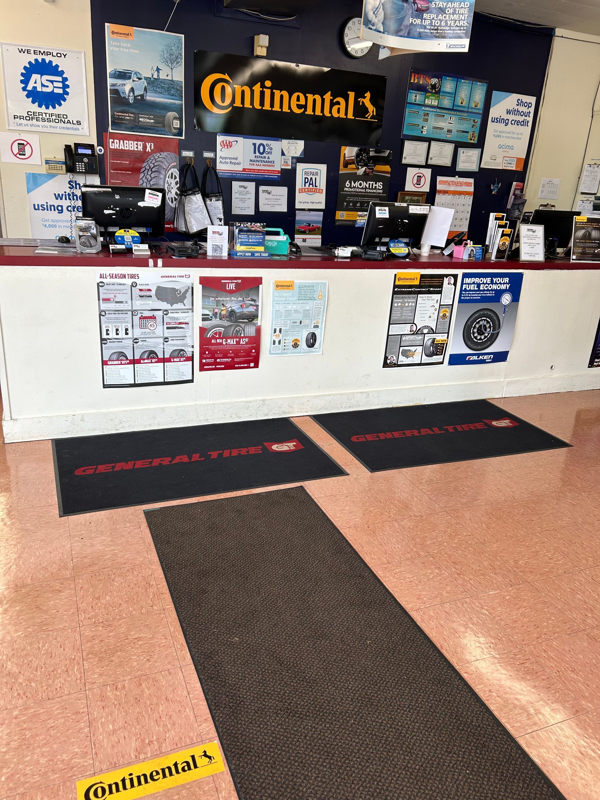 The inside of a tire shop with continental tires on the wall
