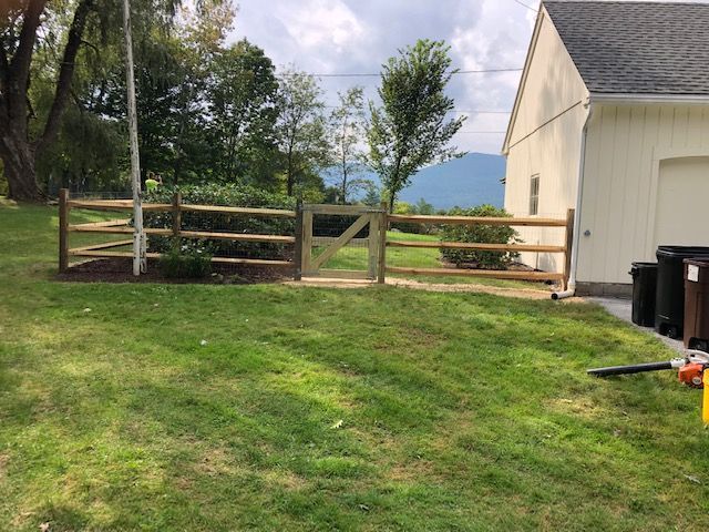 Cornered wooden fence beside a house