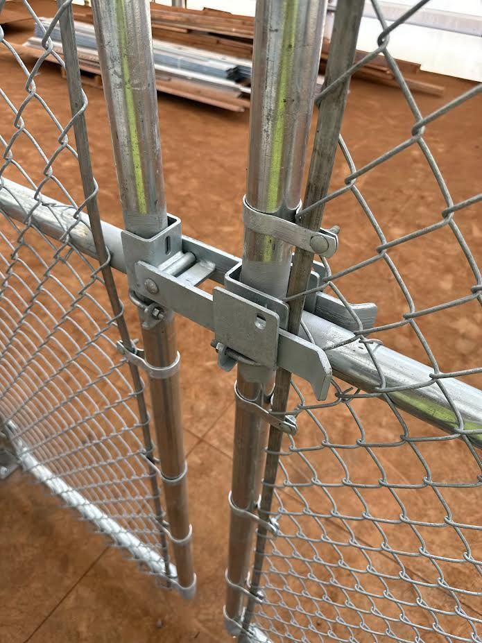 A chain link fence with a gate attached to it.