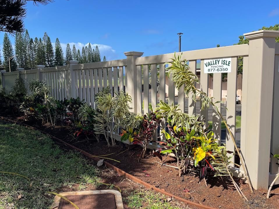 A white fence with a sign that says valley isle