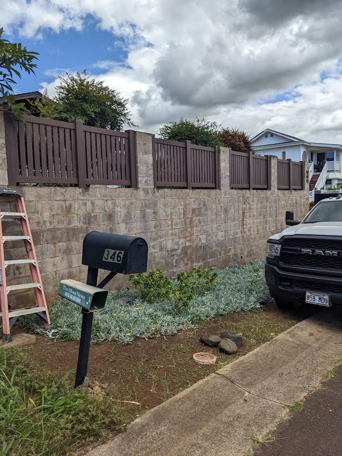 A mailbox is sitting in front of a brick wall.