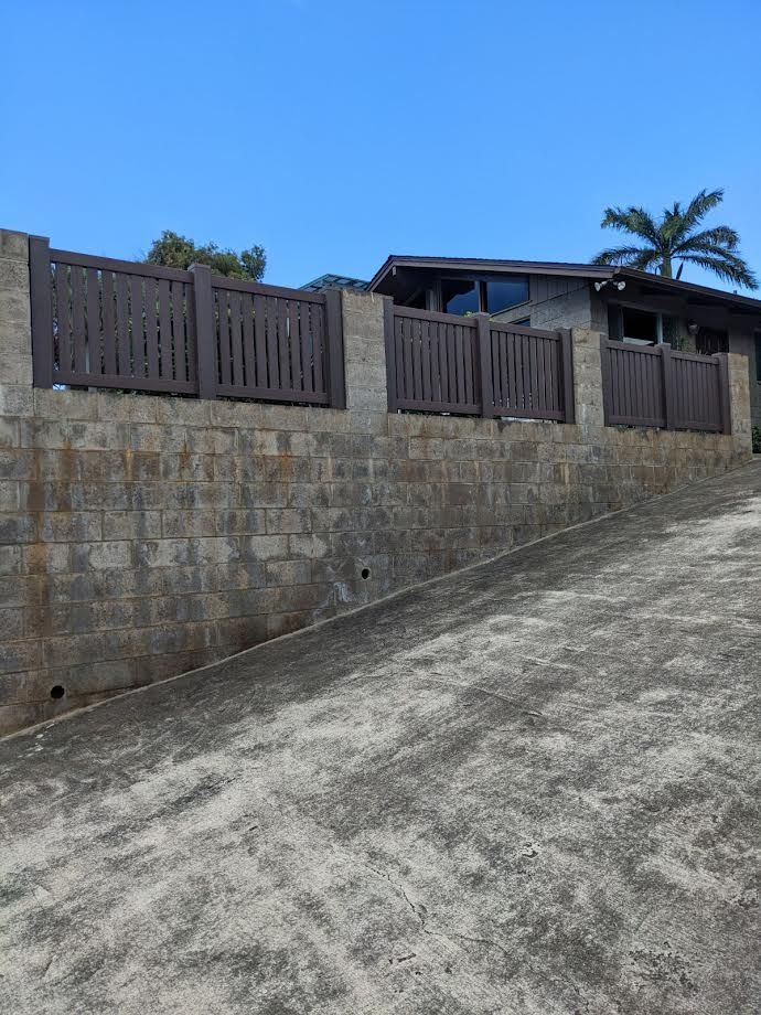 A house with a brick wall and a wooden fence
