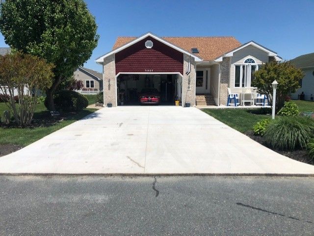 A house with a red garage door and a concrete driveway
