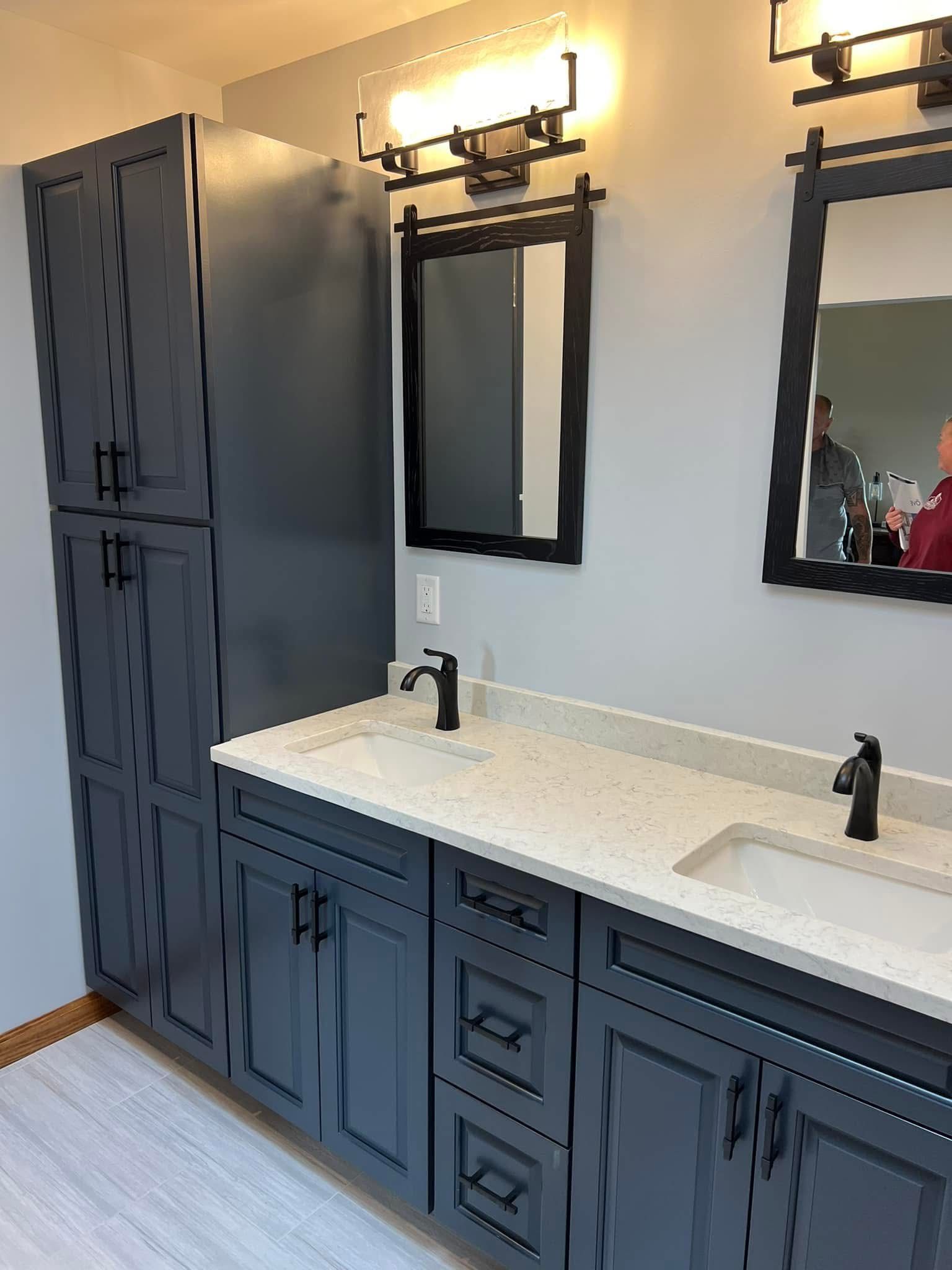 A bathroom with two sinks and two mirrors.