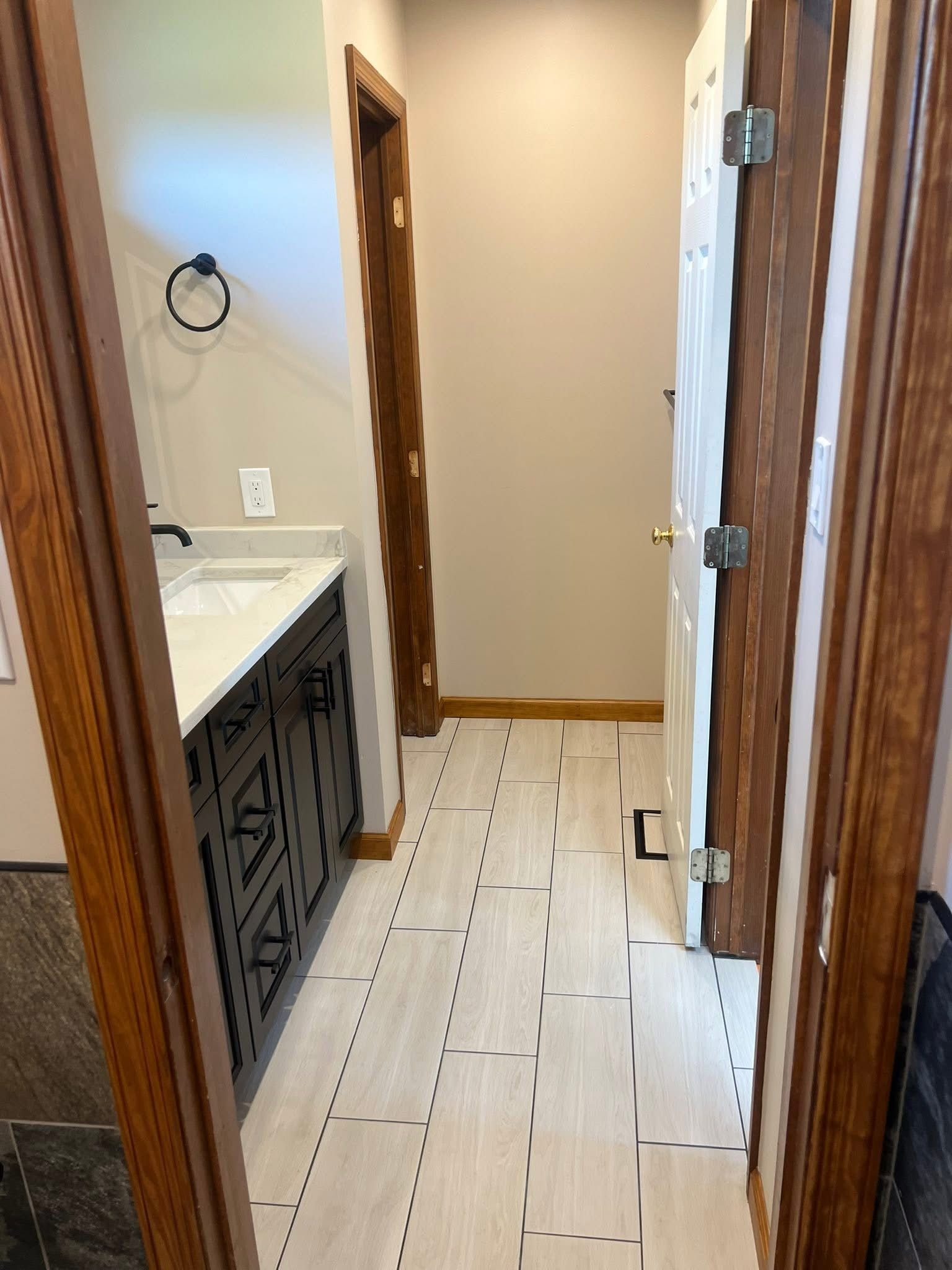 A bathroom with a sink , toilet , and door.