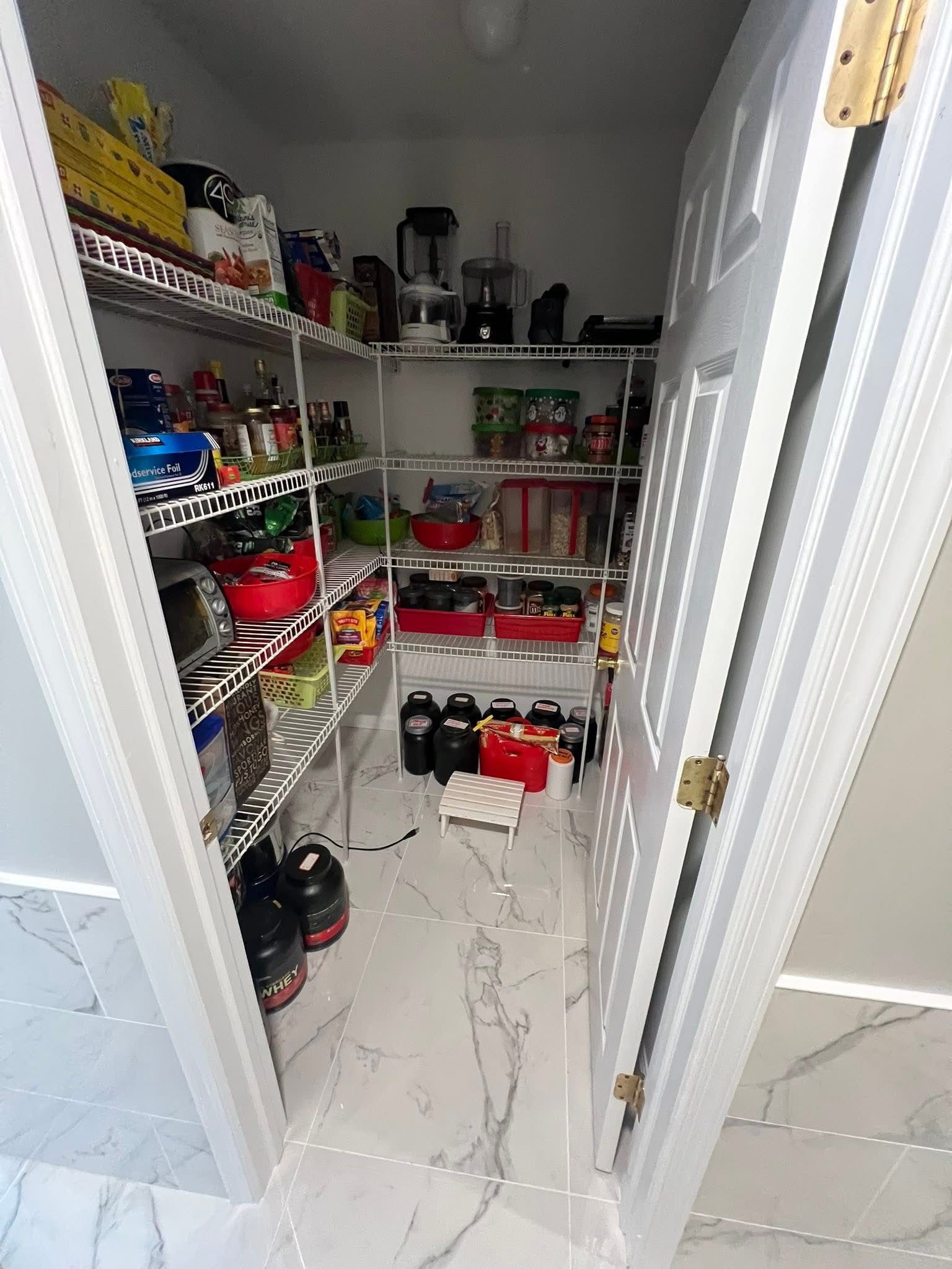 A pantry filled with lots of food and appliances.