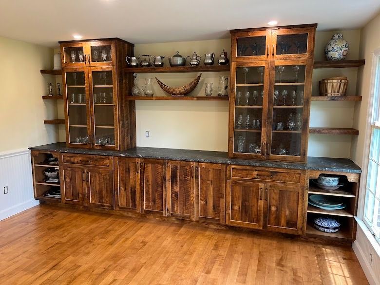 A kitchen with a lot of wooden cabinets and shelves