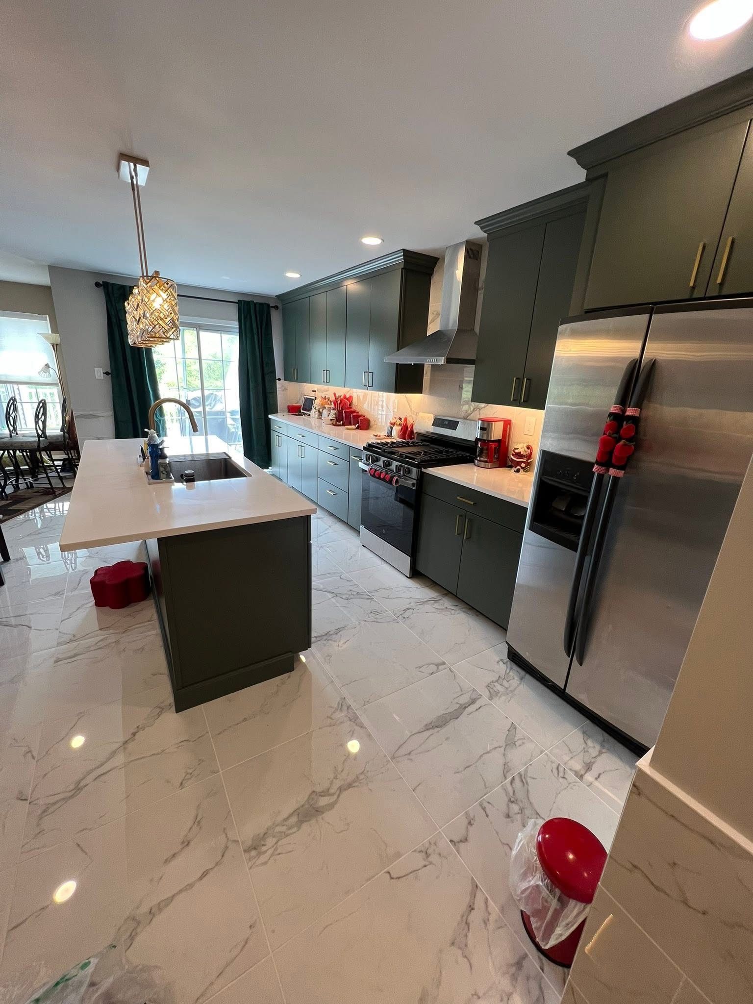 A kitchen with stainless steel appliances and marble floors.