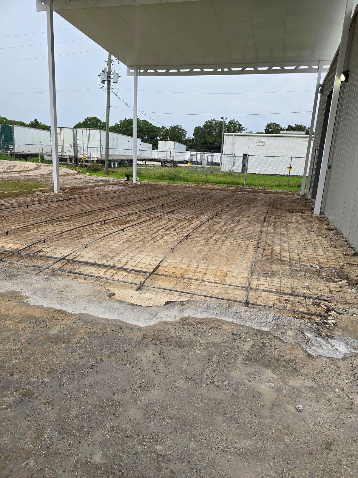 A concrete driveway is being built in front of a building.