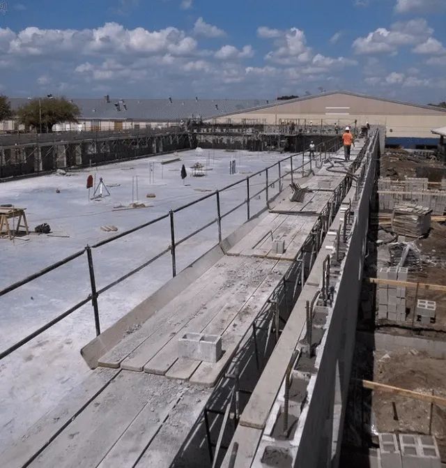 A construction site with a fence and a lot of scaffolding