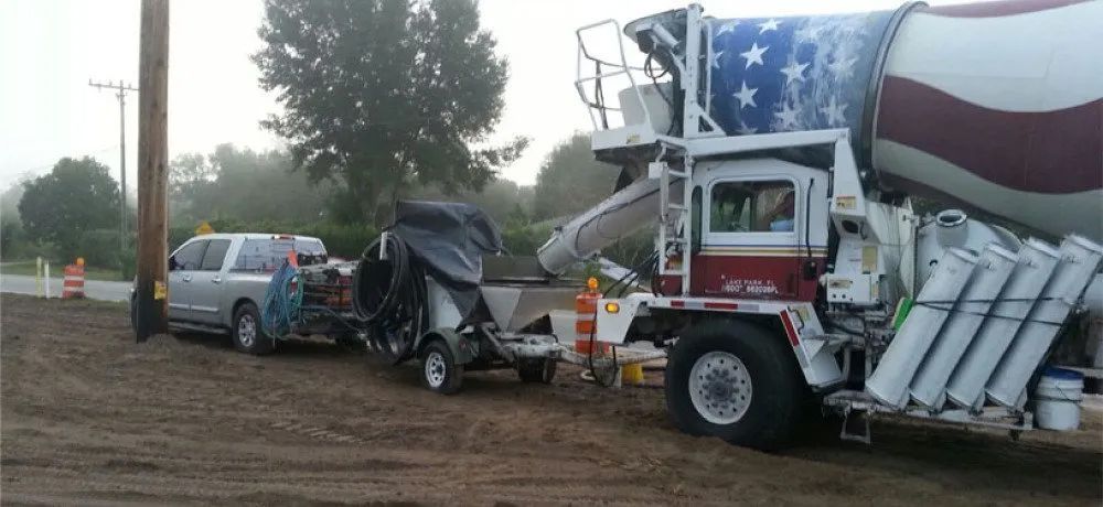 A concrete mixer truck with an american flag painted on it