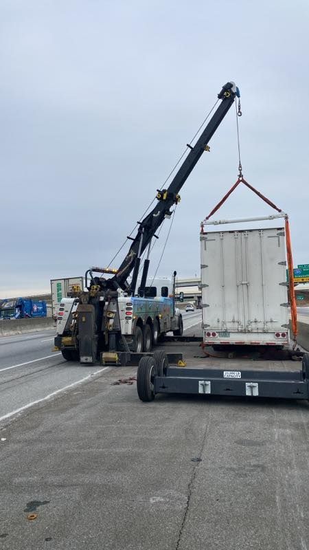 Crane lifting a shipping container on a dockside lot