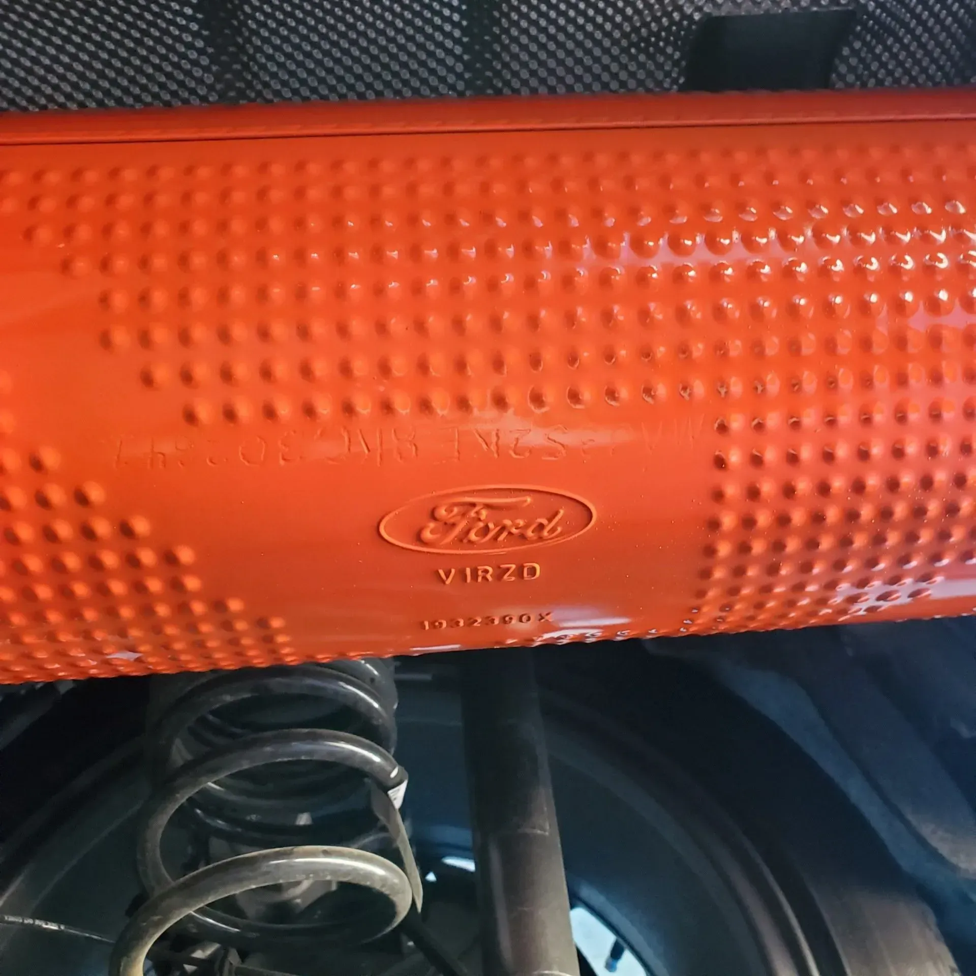 Orange Ford instrument panel with textured surface and visible air vent below