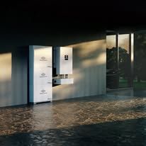 Modern lobby with a white wall-mounted kiosk beside glass doors and reflections on a glossy floor