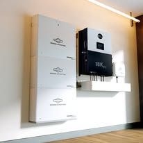 Wall-mounted white and black home appliance system in a bright modern room