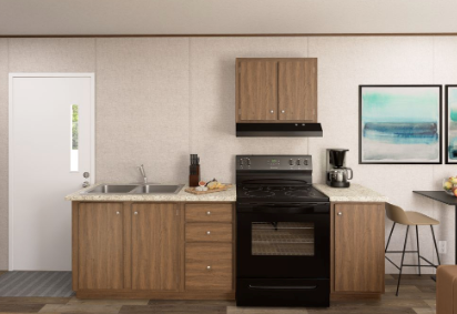 Modern kitchen with wood cabinets, black stove, white walls, and framed ocean artwork