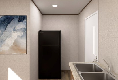 Narrow kitchen with black fridge, sink, and abstract wall art in a small modern room