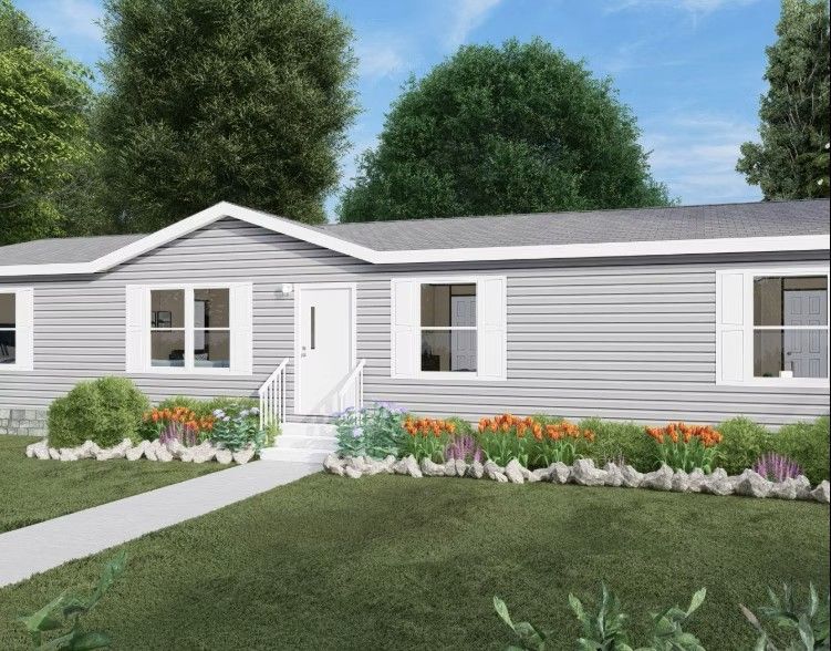 Gray house with white trim, door, and windows; walkway and flowerbed in front.