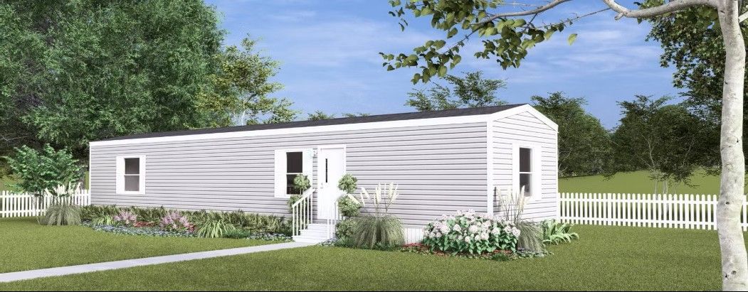 White house with picket fence and greenery.