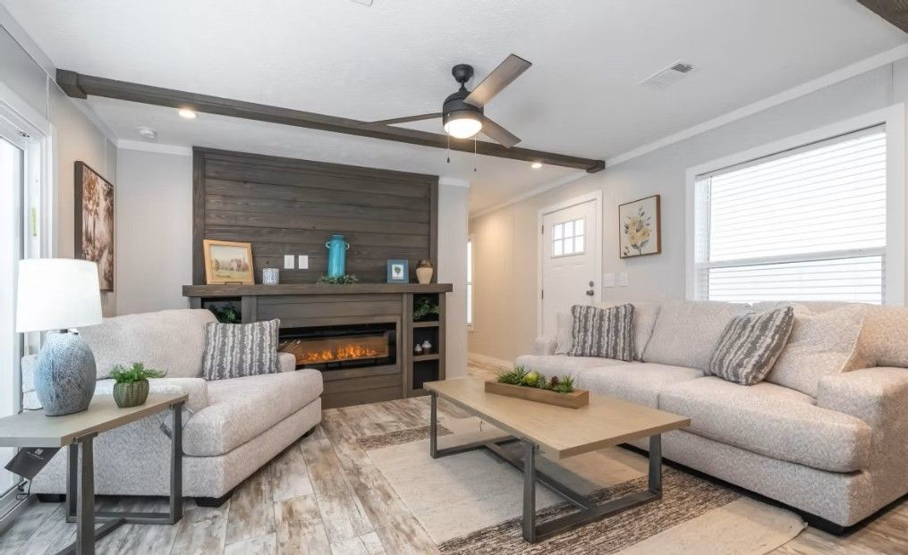 Living room with fireplace, sofas, and coffee table in a modern home.