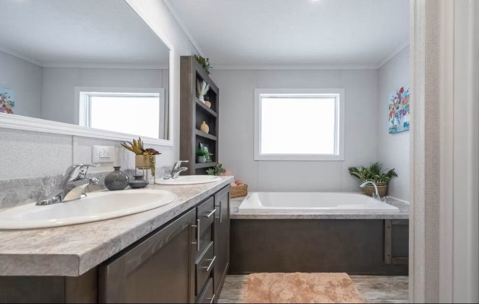 Bathroom with double sinks, tub, shelving, neutral colors.