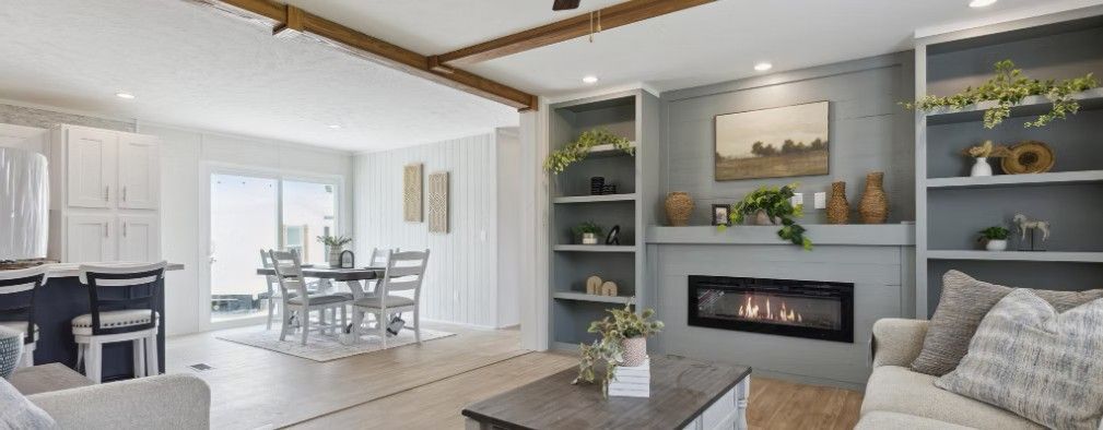 A light and airy living room with a fireplace, open to a dining area.