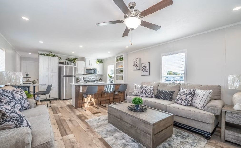 Open-concept living space with kitchen, seating area, and wooden accents. Bright, airy, and modern interior design.
