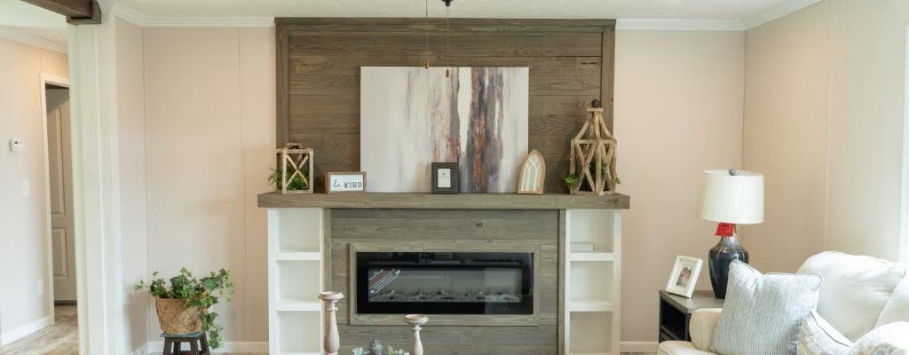 Living room with fireplace, art, and couch.  Neutral color palette.