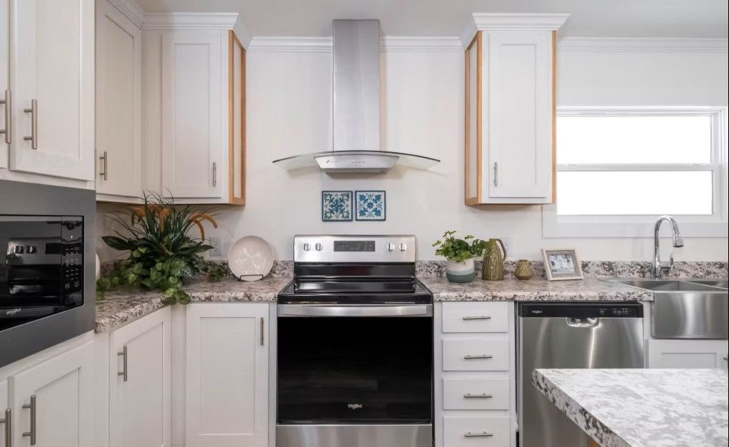 Kitchen with white cabinets, stainless steel appliances, and granite countertops.