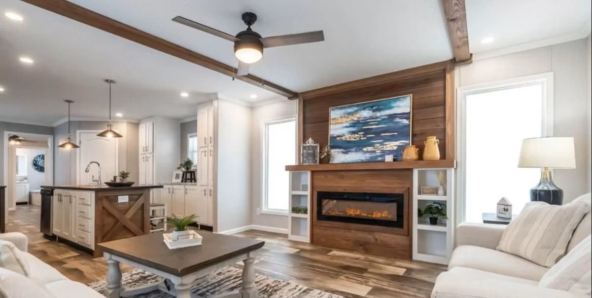 Cozy living room with a fireplace, open kitchen, and neutral-toned furniture.