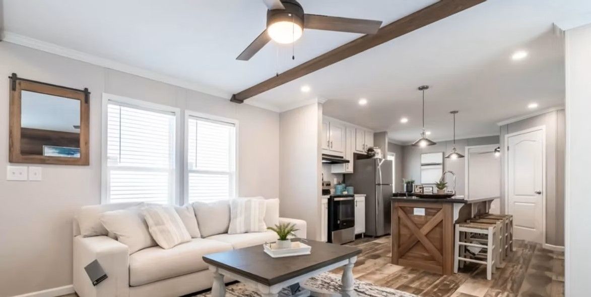 Living room with sofa, windows, and kitchen island.