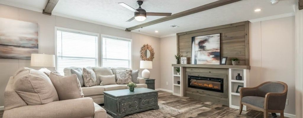 Cozy living room with a fireplace, sofa, and accent chair. Neutral colors, natural light.