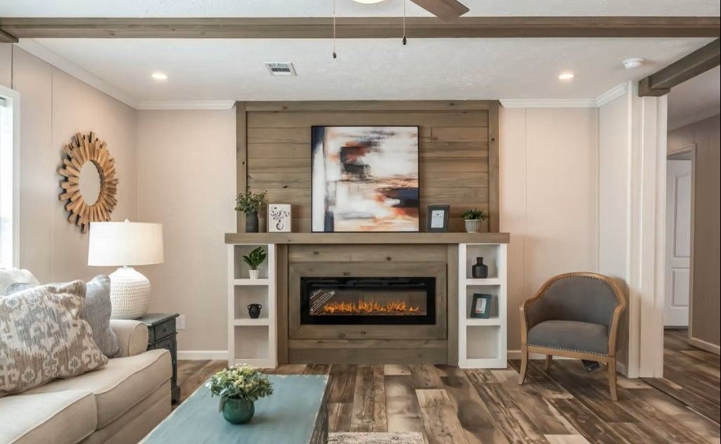 Living room with fireplace, built-in shelves, sofa, accent chair, and artwork.