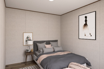 Minimal bedroom with gray bed, beige walls, framed art, and a small bedside table