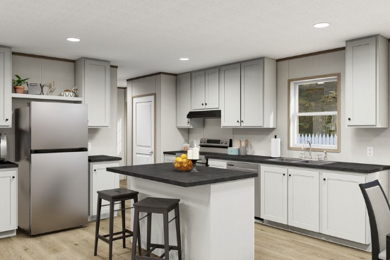 Bright modern kitchen with gray cabinets, stainless fridge, island, stools, and window above the sink