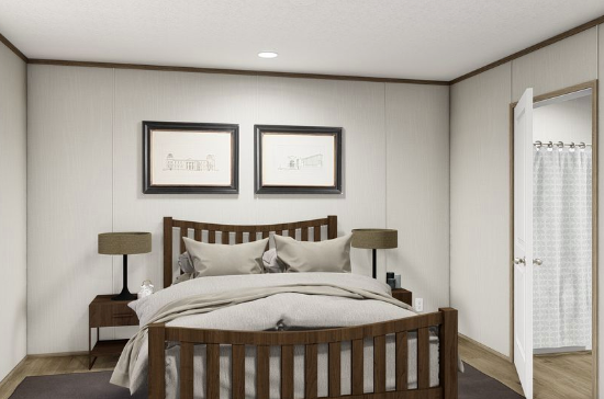 Minimalist bedroom with a wooden bed, two bedside lamps, framed art, and an open door to a closet