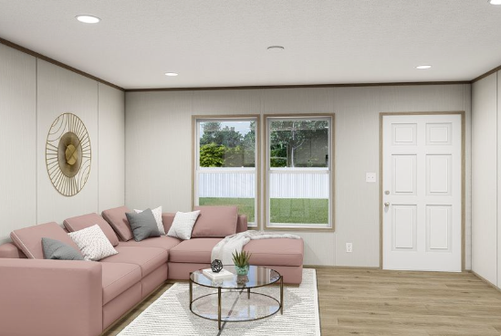 Modern living room with pink sectional sofa, round glass coffee table, and large window view.