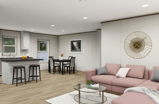 Modern open-concept living room and kitchen with pink sofa, black stools, and light wood floors.