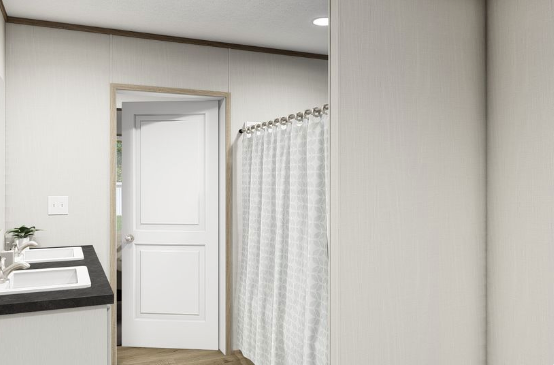 Modern bathroom with a white door, shower curtain, and black vanity counter on the left.