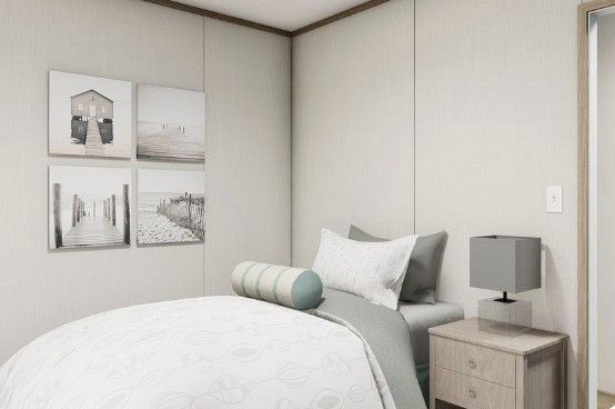 Minimal bedroom with a white bed, gray bedside lamp, and framed wall art